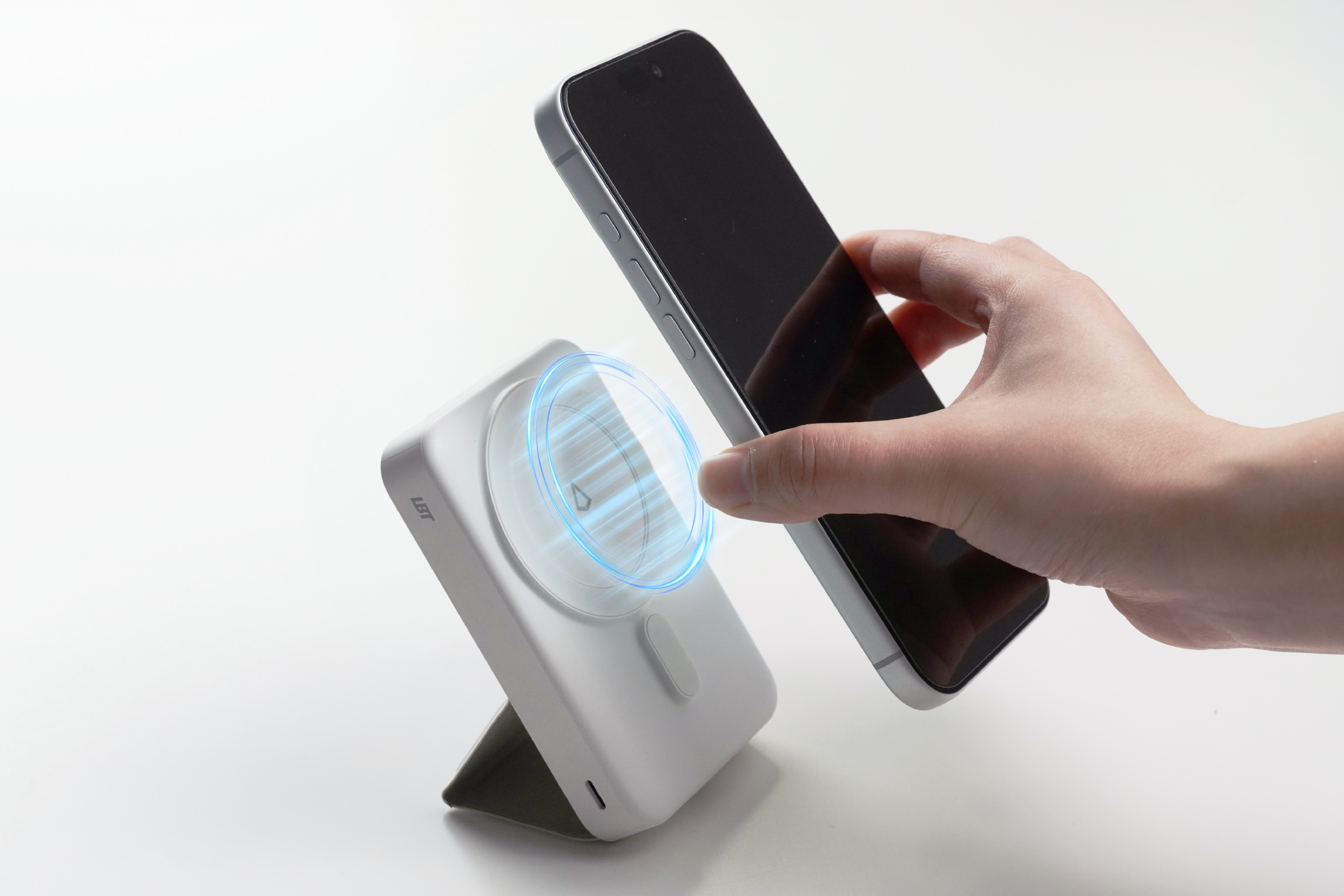 Hand using a smartphone to scan a QR code on a white surface